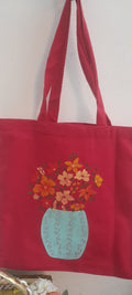 Blue vase on red canvas tote bag